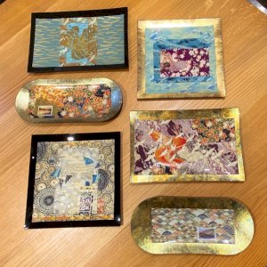 In store only: Chigirie Glass Plates. Artist Guitta Corey has lived in Alaska since 1979. She has a BFA from the Rhode Island School of Design. Printmaking, pastel, and paper collage are her preferred mediums. Her current collages are in a style known in Japan as Chigirie, or painting with paper.